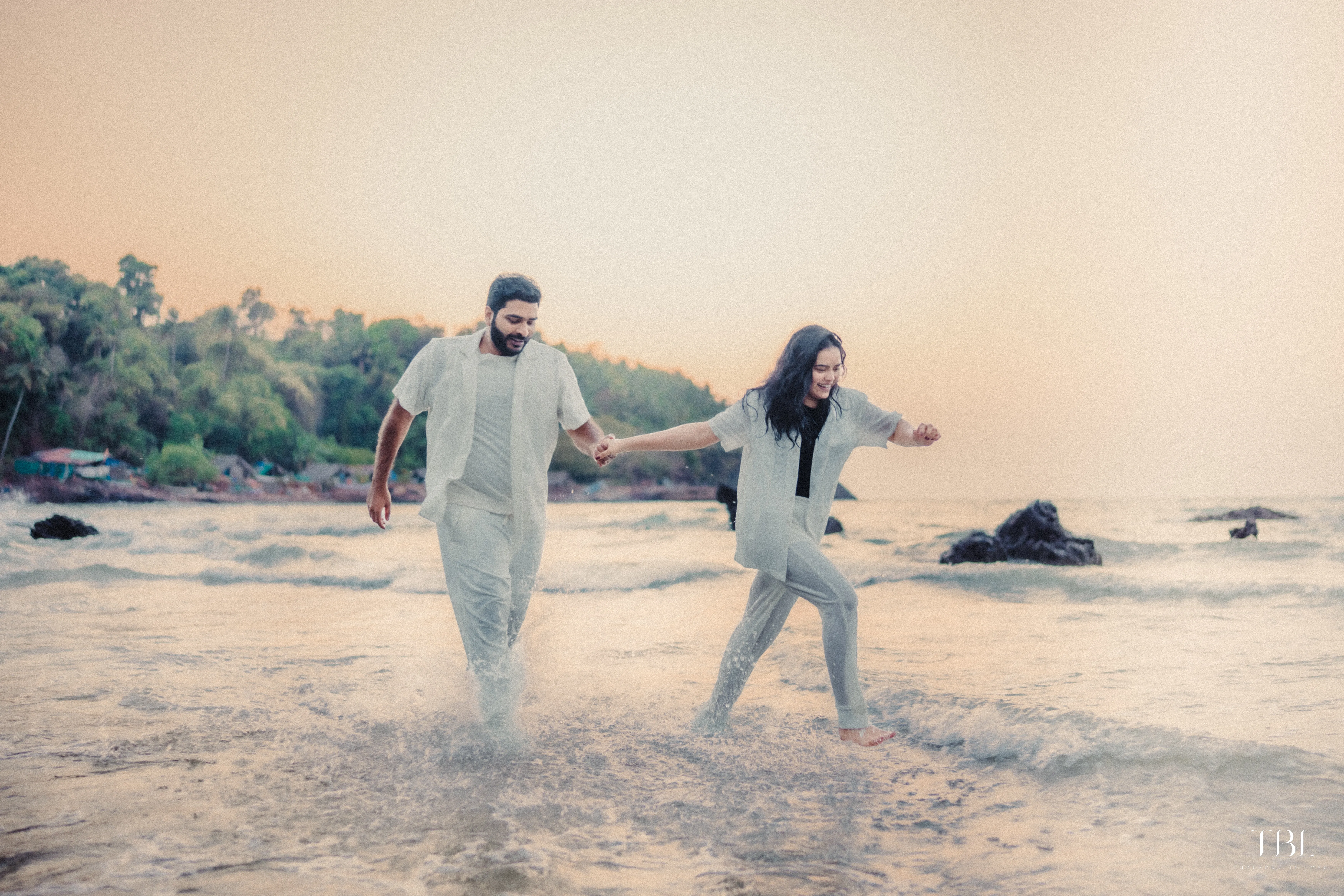 Anusha and Satya smiling beautifully during their outdoor luxury wedding portrait session