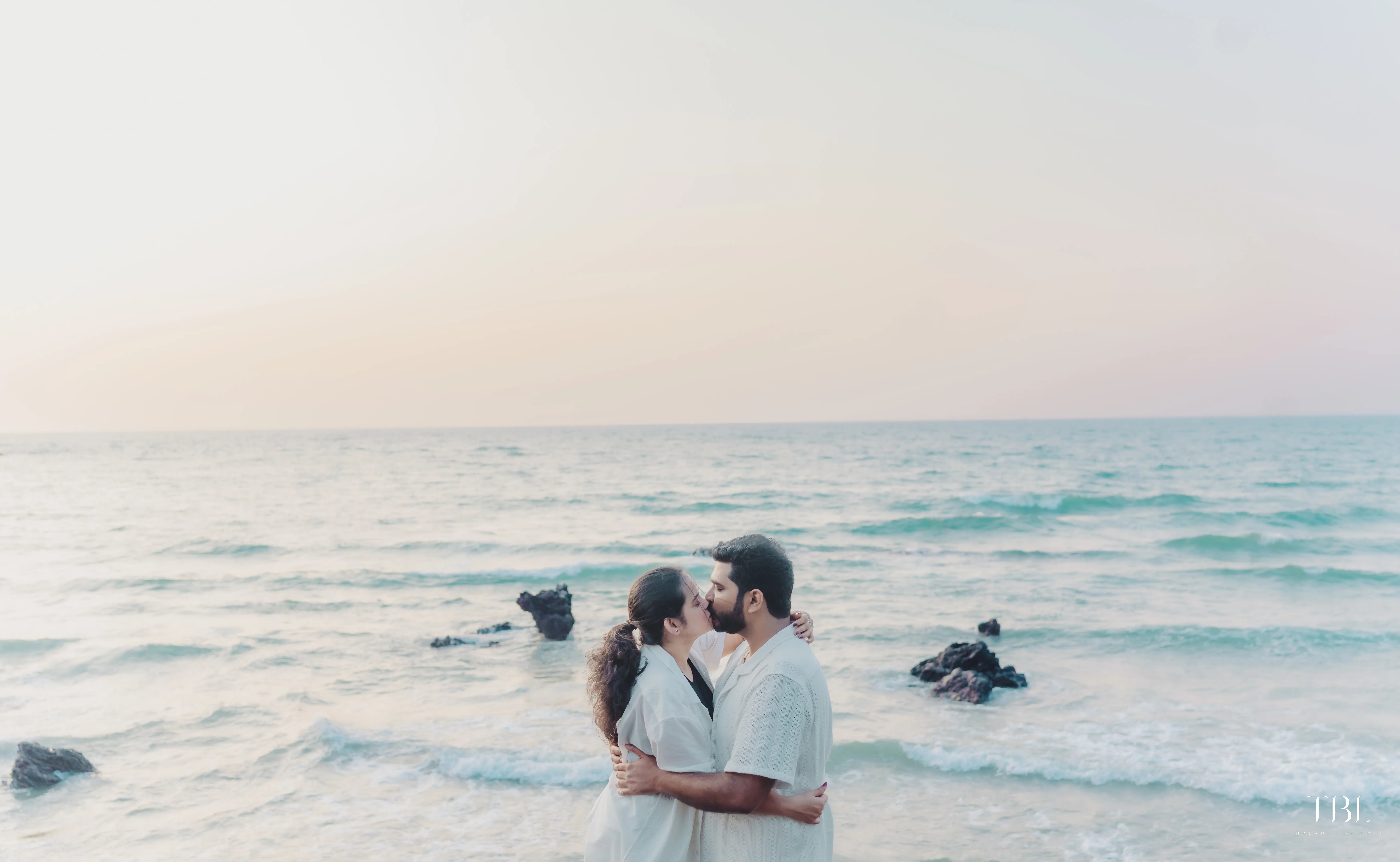 Solo portrait frame featuring bride Anusha smiling softly at a breathtaking beach coastal view outlook spot
