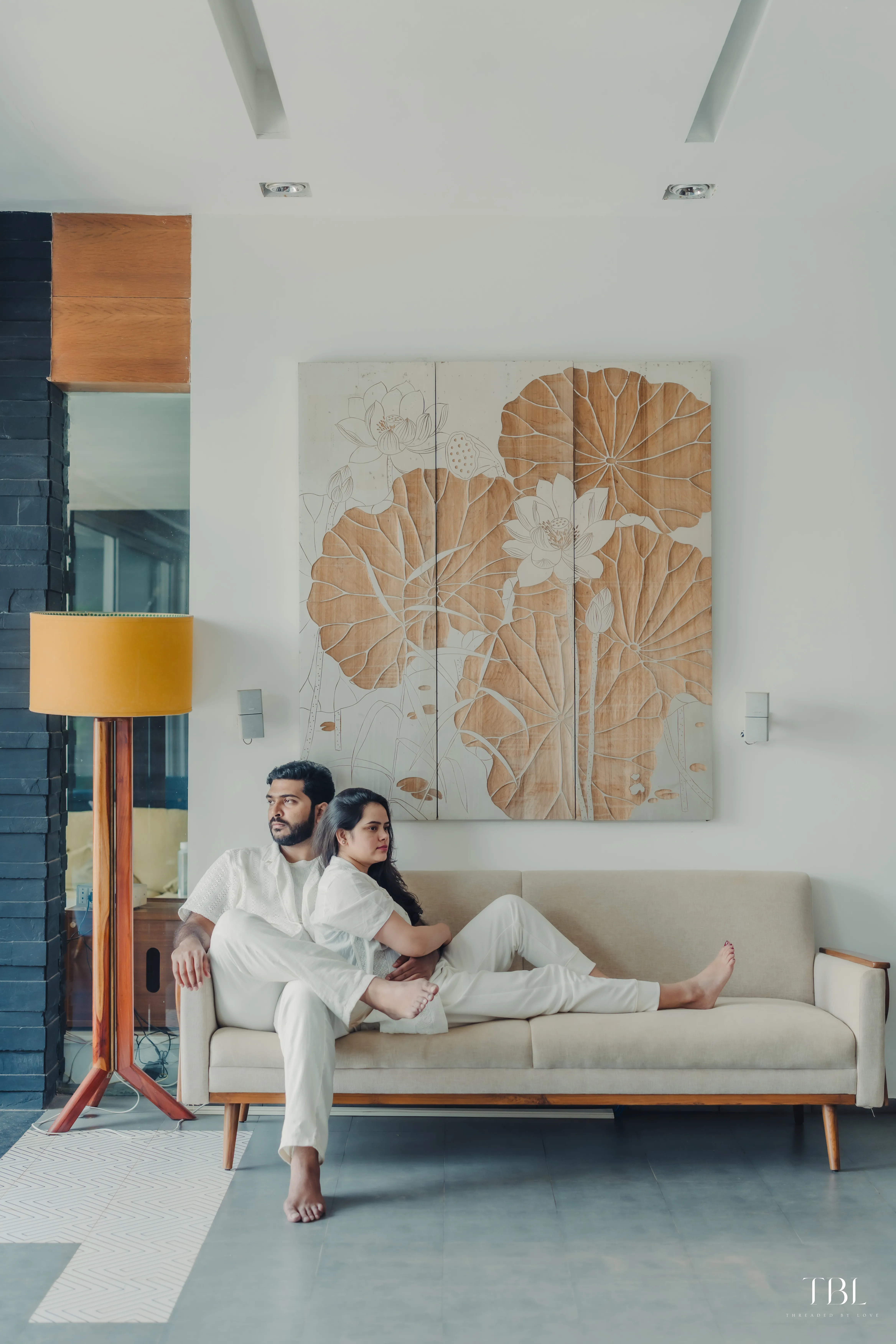 Anusha and Satya posing gracefully inside a beautifully lit venue space during their indoor portrait shoot