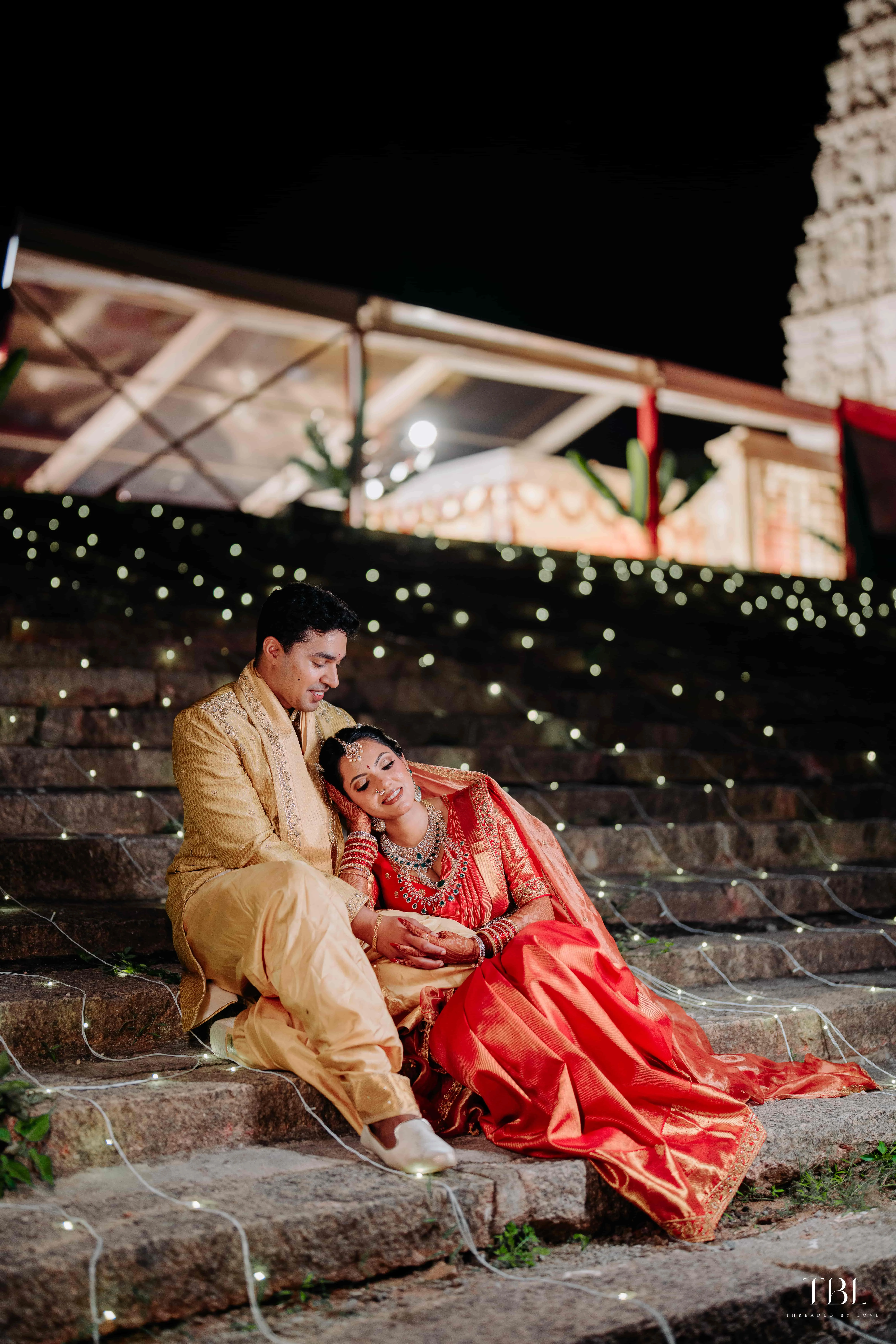 Anusha and Satya chilling happily on the beach sand during their casual wedding portraits session
